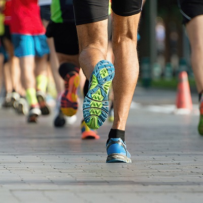 Marathon running race, people feet on city road