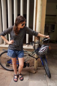 Young woman standing with a bicycle