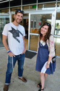 Young man and woman standing together on a street