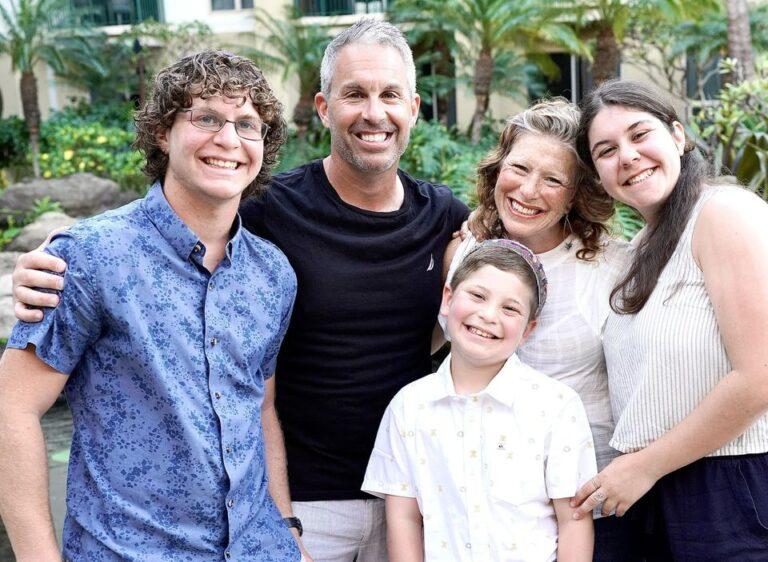 Family of six smiling together outdoors
