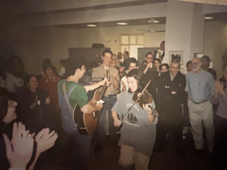 Alicia Jo Rabins with people dancing at a celebration