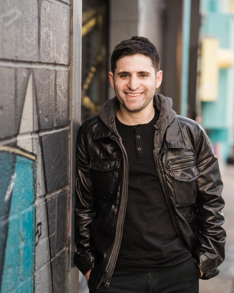 Aaron Lerner in a leather jacket on a city street